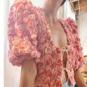 Born 3D rosette pink blouse featuring handsewn roses with a tie front. Size XS